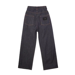 Raw denim streetwear jeans side fit — pleated silhouette with relaxed hip and tapered leg on model